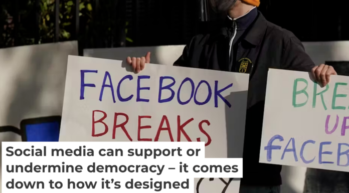 A protester calls out Facebook for facilitating the spread of disinformation. AP Photo/Jeff Chiu